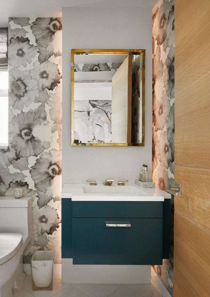 We added a powder room to the floor plan, designing a custom lacquered vanity with backlighting and floral Phillip Jeffries wallpaper. The mirror is vintage.
﻿Photo: Gieves Anderson.